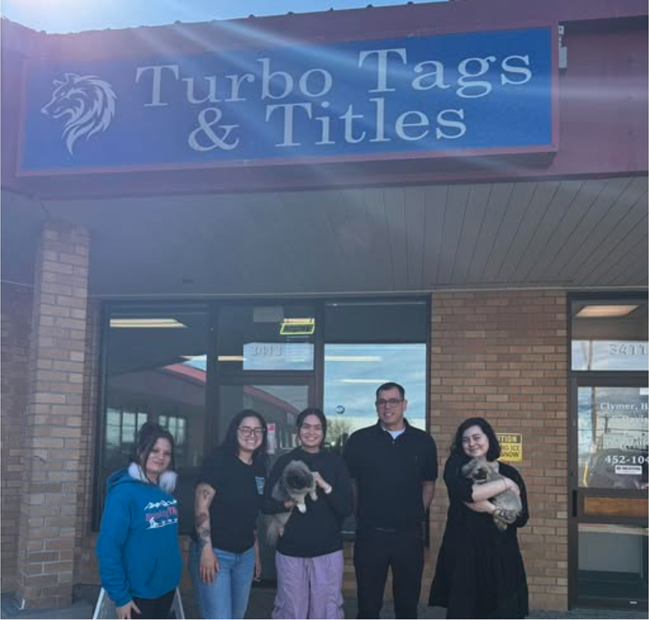 Patrick and the Turbo Tags & Titles team outside the Fairbanks storefront with rescue pets
