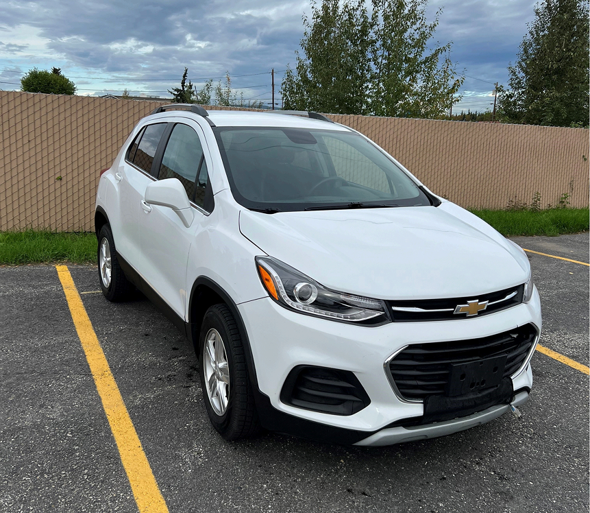 The Turbo Tags & Titles road testing vehicle — a white Chevrolet SUV parked outside our Fairbanks office.